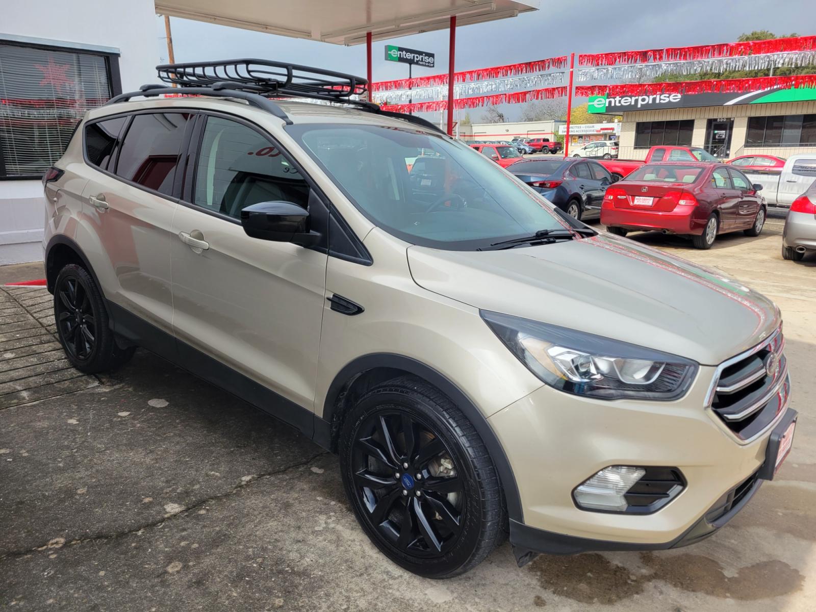 2018 Gold Ford Escape (1FMCU9GD5JU) with an 1.5L I4 F DOHC 16V engine, Automatic transmission, located at 503 West Court, Seguin, TX, 78155, (830) 379-3373, 29.568621, -97.969803 - 2018 Ford Escape SE 4WD with a 1.5L I4 F DOHC 16V, Automatic, Tilt, Cruise, AM/FM/CD Touchscreen Stereo, Power Windows, Locks, Seat and Side Mirrors, Bluetooth, Navigation, Automatic Headlights, Dual Climate Control, Rear A/C, Heated Seats, Tinted Windows, Luggage Rack, Backup Camera, Bumper Sensors - Photo #1